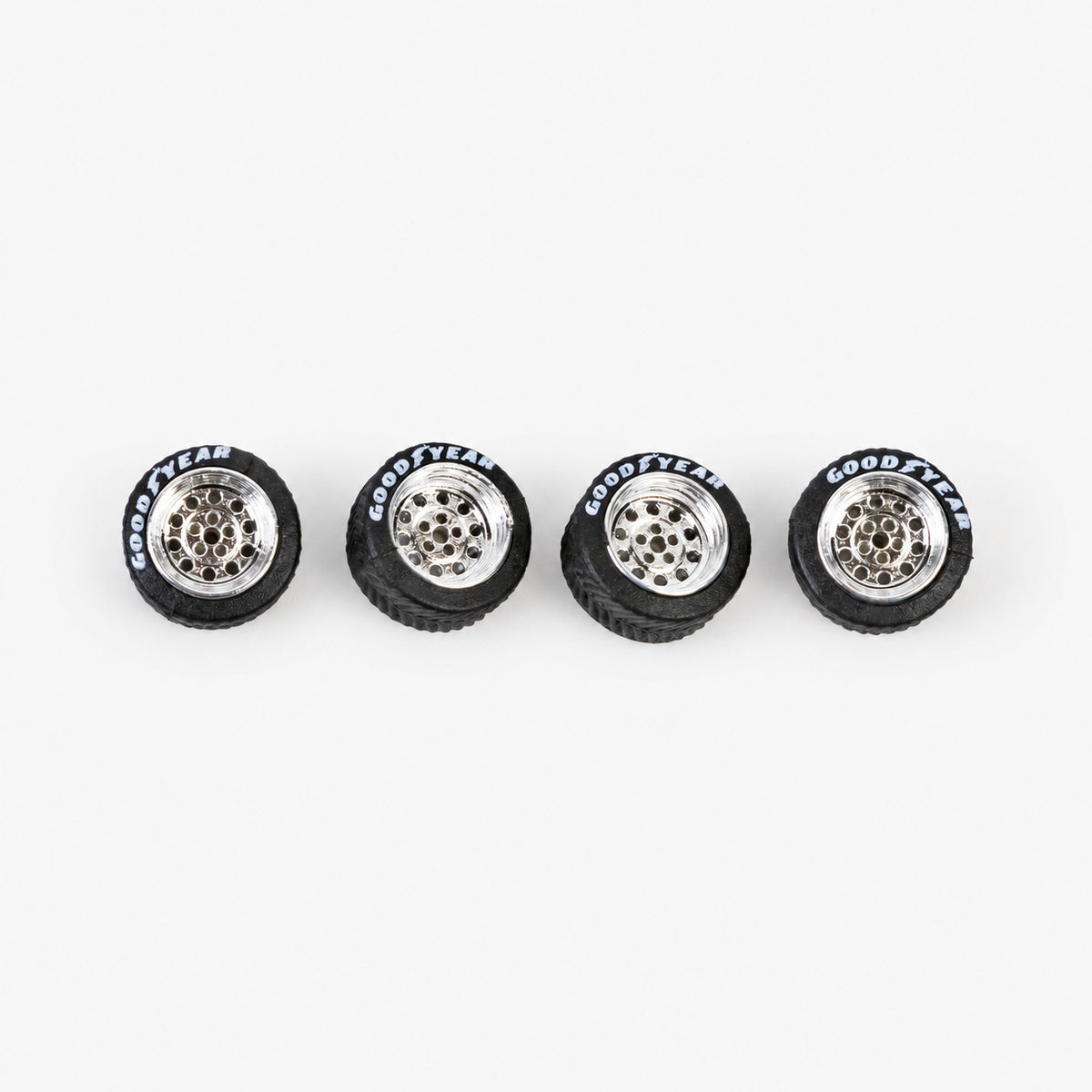 Four chrome Dots-style miniature wheels with black lettered tires