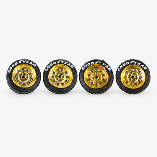 Four gold Dots-style miniature wheels with black lettered tires