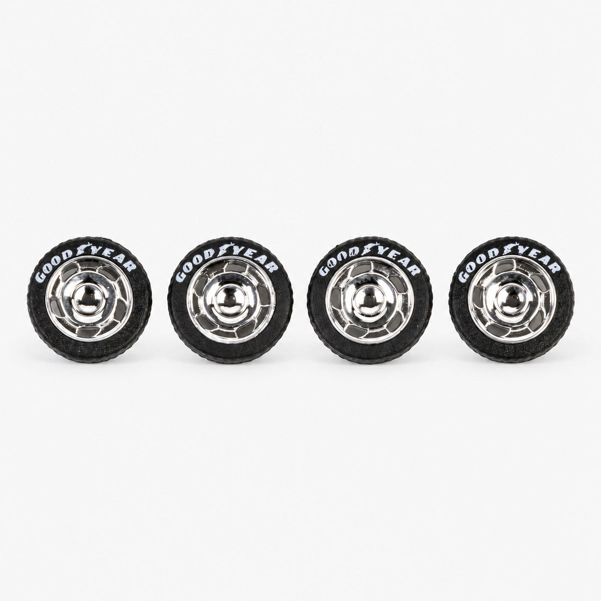 Four chrome VW-style miniature wheels with black lettered tires
