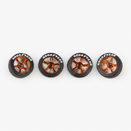 Four bronze five-spoke miniature wheels with black lettered tires