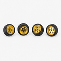 Four gold five-spoke miniature wheels with black low-profile tires on a light background