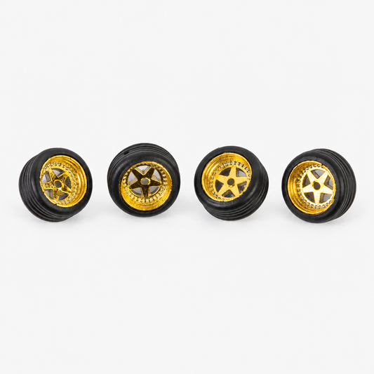Four gold five-spoke miniature wheels with black low-profile tires on a light background