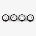 Four white five-spoke miniature wheels with black low-profile tires