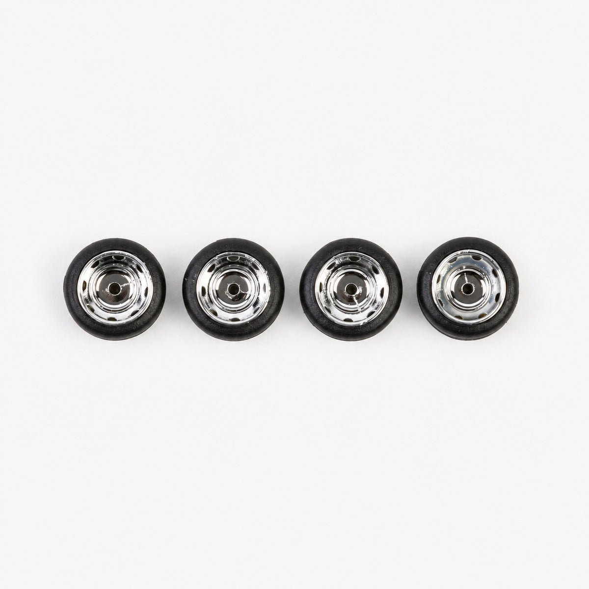 Four chrome Steely-style miniature wheels with black low-profile tires