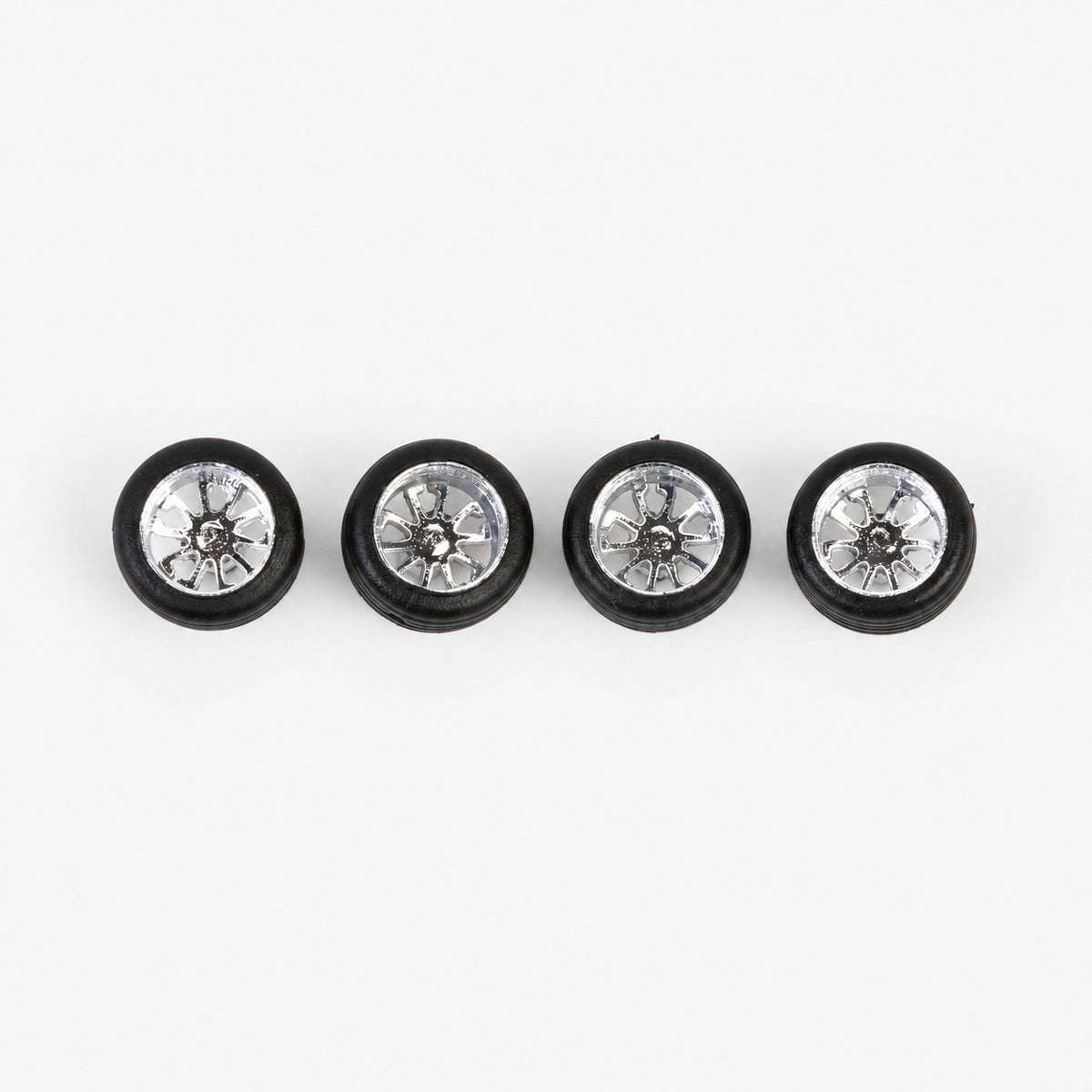 Four chrome ten-spoke deep-dish miniature wheels with black low-profile tires