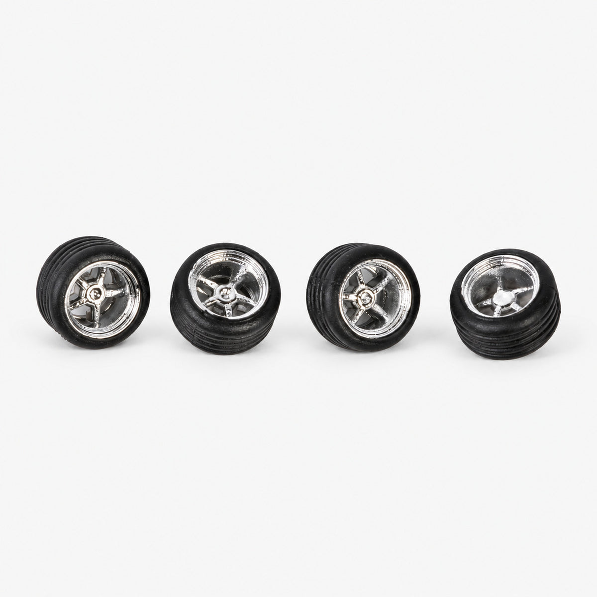 Four chrome five-spoke Cragar-style miniature wheels with black tires