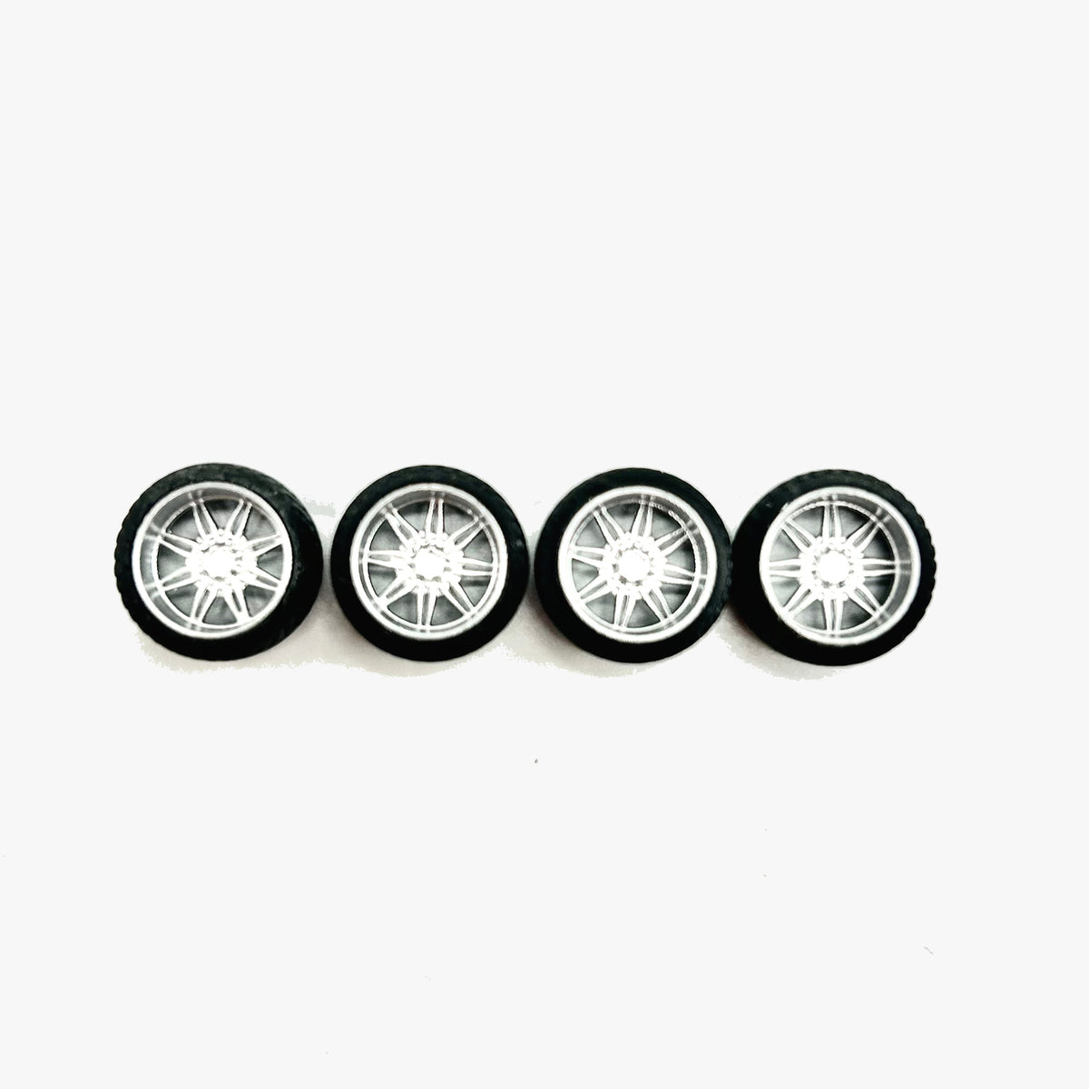 Four chrome KG1 Aristo miniature truck wheels with black RT tires